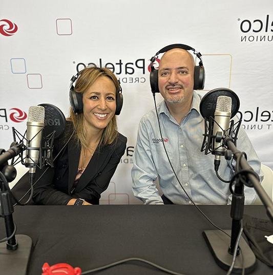 Patelco employees Michele Enriquez and Luis Jara at the podcast desk